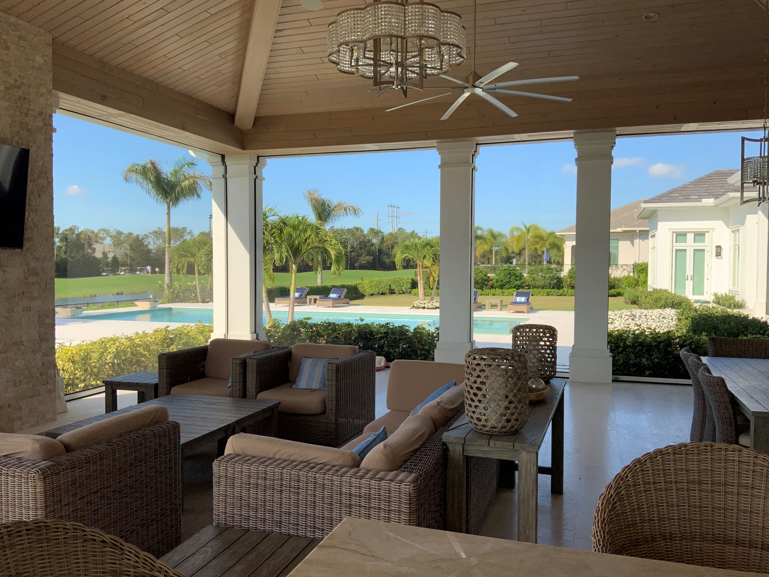 Motorized MagnaTrack hurricane screen with recessed track installed on a residential home